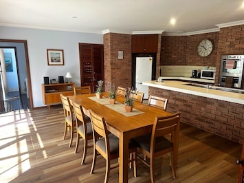 Open plan kitchen dining with large doors opening to back patio.