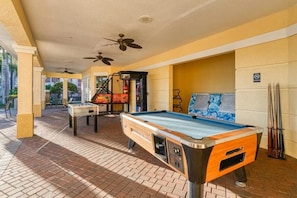 Relax and socialize in our indoor recreational area, featuring a pool table, foosball table, and billiards table.