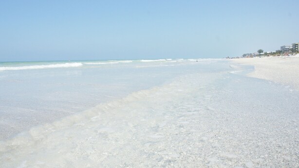 A wide sandy beach with gentle waves and a clear sky. - Fall Savings! Gulf-View 2BR2BA 
Beach Condo with private balcony. (Indian Rocks Beach)