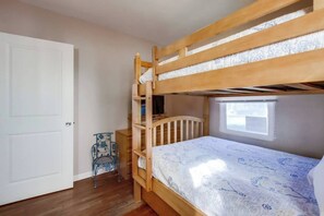 A bunk bed room with a window, a door, and a chair. - Charming PB bungalow, pet-friendly yard, parking (San Diego)