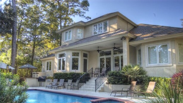 A two-story house with a swimming pool, outdoor seating, and a covered patio. - 2 Master Suites. 80 Reviews.
Great Backyard. (Hitlon Head)