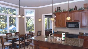 A kitchen with wooden cabinets, granite countertops, and pendant lighting. - 2 Master Suites. 80 Reviews.
Great Backyard. (Hitlon Head)