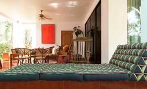A cozy living area with a sofa, chairs, and a dining table.