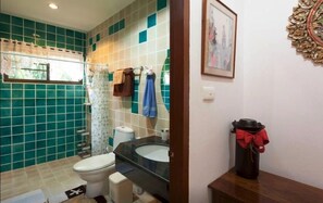 A bathroom with a toilet, sink, and shower area. - Teak Room with Mountain View (Tambon Nong Kwai)