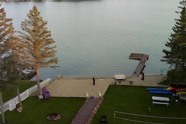 Aerial view of backyard with sandy beach