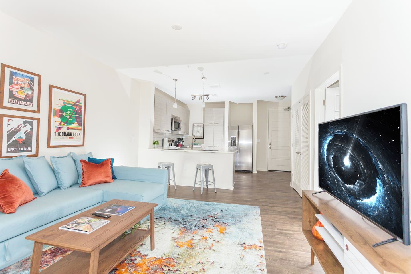A modern living room with a sofa, coffee table, and artwork on the wall.