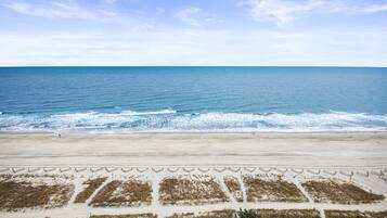 A beach with a sandy shore and waves.