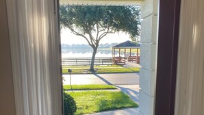 A view through a doorway to a covered outdoor area with a bench and a gazebo. - Quiet and beautiful place (Kissimmee)