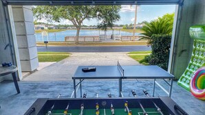 A foosball table with a view of a lake and park area. - Quiet and beautiful place (Kissimmee)