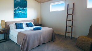 A bedroom with a bed, a ladder, a chair, and a painting on the wall. - SORRENTO TENNIS RETREAT - 4BR and tennis court, just 5min walk to Sorrento strip (SORRENTO)
