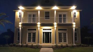 A large, two-story house with a symmetrical facade, evenly spaced windows, and a central entrance.
