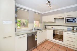 Fridge, stovetop, dishwasher, coffee/tea maker