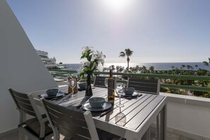 Enjoy a romantic meal on the balcony with ocean views and a beautiful garden setting.
