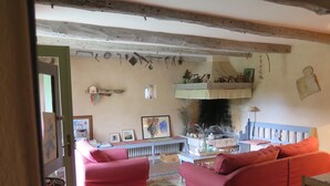 A cozy living room with red sofas, a fireplace, and various wall decorations. - Holiday Home Augusta (Zminj)