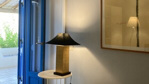 A room with a bed, a lamp, a door, and a framed picture on the wall. - Aeolian Island Villa-Detached villa LIPARI, private pool with stunning sea view (Lipari)