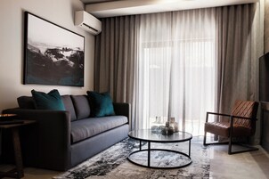 A modern living room with a sofa, a coffee table, and a chair.