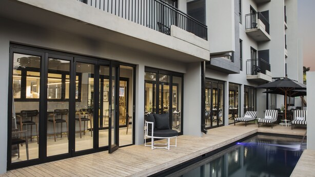 Een modern hotel met een zwembadgedeelte, terras en uitzicht op de binnenterras.