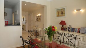 A dining area with a glass table, metal chairs, and a vase of flowers. - Sea view, Beach-Front Cannes Apart, Central,  2 Bed/2 Bath,A/C,Parking, Wifi (Cannes)
