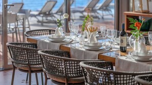 A dining area with tables set for a meal, overlooking the sea. - House / Villa - Castiglioncello(LI) (Castiglioncello)