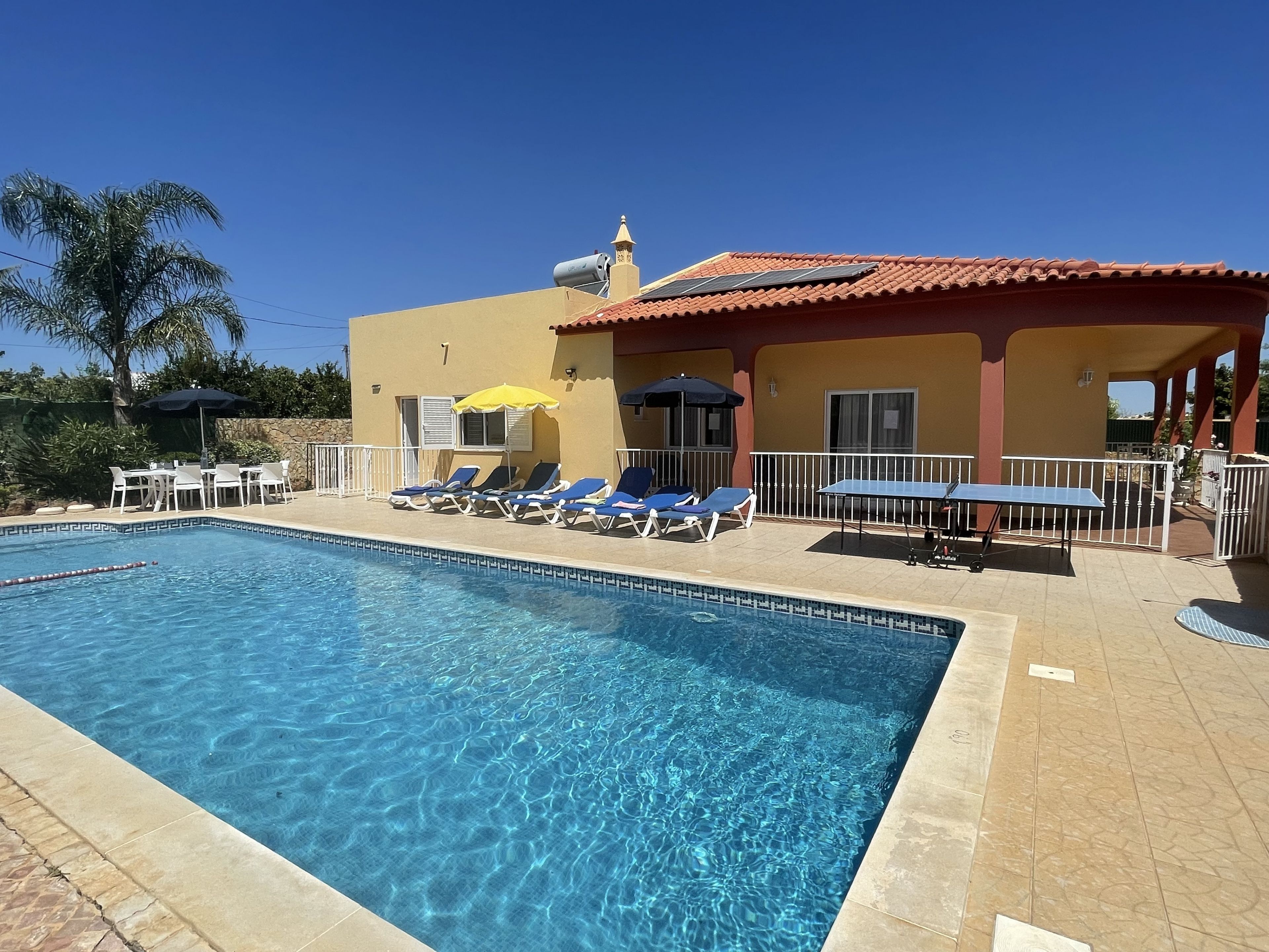 A heated pool, sun loungers
