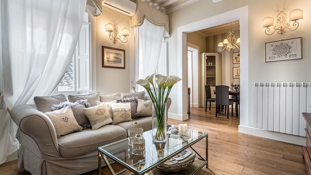 Un salon avec un canapé, une table basse en verre et des objets de décoration.