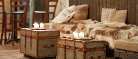 A cozy bedroom with a large bed, wooden headboard, and a rustic chest of drawers.