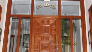A wooden double door with a sign above it that reads "LUX CENTER".