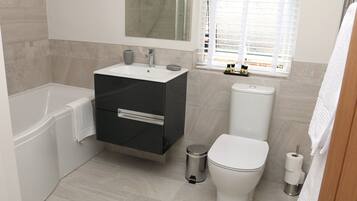 Combined shower/bathtub, hair dryer, towels, soap