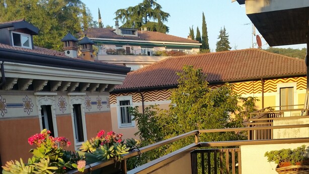 Ein Balkon mit Tisch für zwei Personen, ausgestattet mit Teekanne, Tassen und einer Jar an Snacks.