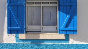 A window with blue shutters and a white frame.