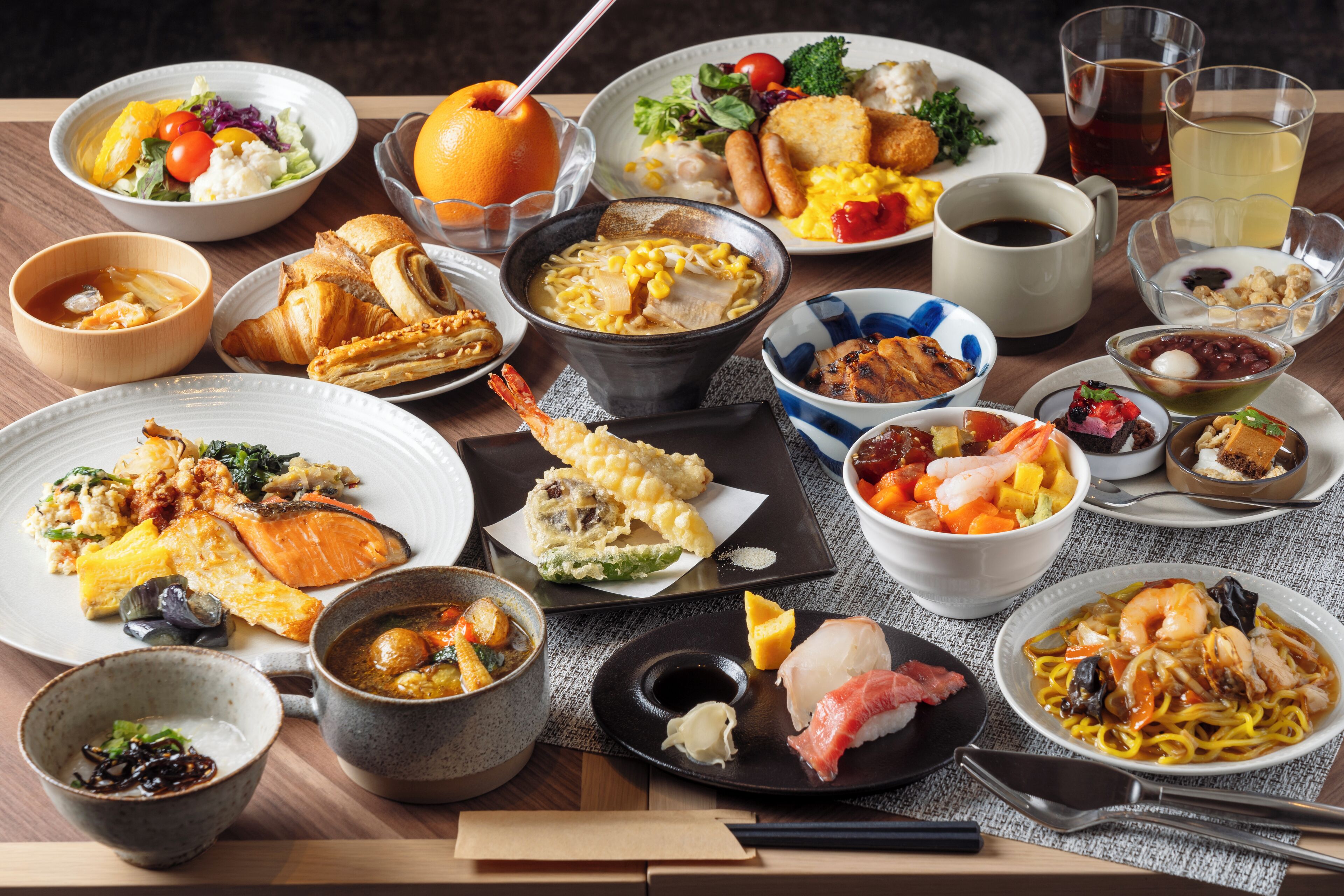 A variety of dishes on a table, including seafood, vegetables, and bread.