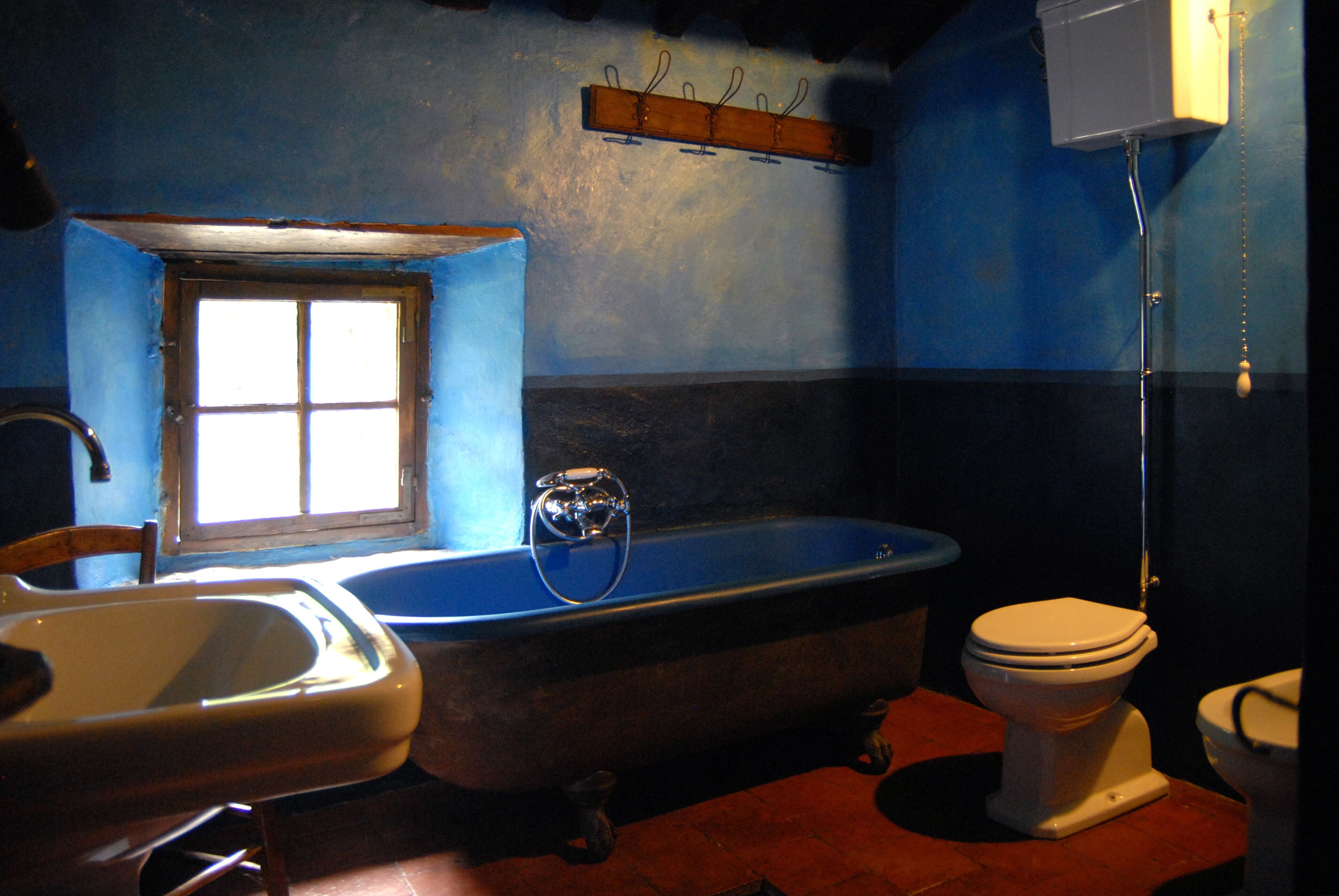 A bathroom with a bathtub, a sink, and a toilet.