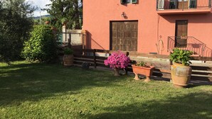 A house with a red exterior, a wooden door, and a balcony with a metal railing. - Holiday home in the Florentine Chianti area (Reggello)