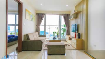 Deluxe Apartment, 2 Bedrooms, Bay View | Living area | 32-inch TV with cable channels
