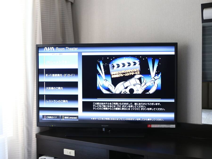 A television displaying a menu for an APAC Room Theater service.