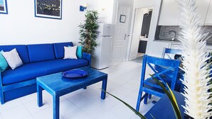 A living room with a blue sofa, a matching coffee table, a side table with a lamp, and a chair. - Sunny and comfy appartment in a residencial development near the sea (Puerto del Carmen, Tias)