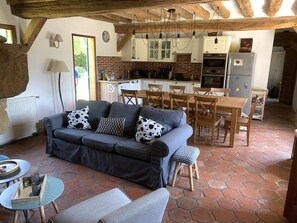 Relax in this inviting space with a comfortable sofa, dining area, and fully equipped kitchen.