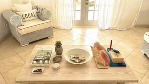 A wooden table with a magazine, a pineapple, seashells, a book, and a beetle. - **** SHIMMERS ****<br> A stunning, stylish West coast villa close to Mullins beach (Mullins)