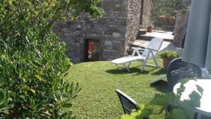 A stone building with a small patio area, a fire pit, and white outdoor furniture. - mansion - Riccò del Golfo (Riccò del Golfo)
