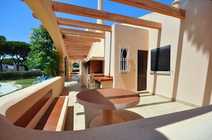 Relax on the shaded patio with a round table and enjoy the serene surroundings.