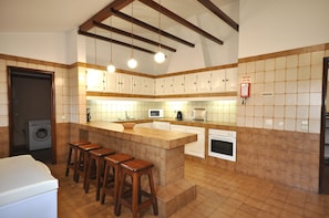 Enjoy cooking and dining in this well-equipped kitchen with a central island, oven, and coffee maker.