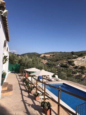 A pool area with a clear view of the surrounding landscape, including terraced fields and a distant hill. - Holiday cottage for 10 people near Antequera (Malaga) (Villanueva de Algaidas)