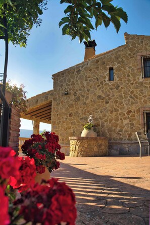 A stone building with a rustic stone wall, a small window, and a chimney. - The Golden Valley: A rural paradise in the Sierra de Cádiz. (El Gastor)