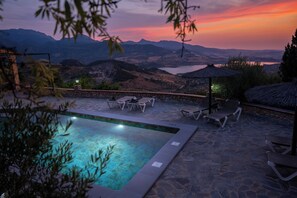 An outdoor swimming pool with lounge chairs and a view of mountains. - The Golden Valley: A rural paradise in the Sierra de Cádiz. (El Gastor)