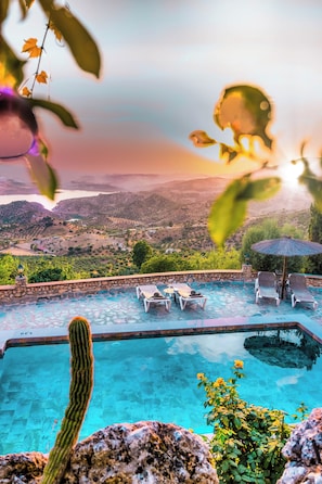 A swimming pool with lounge chairs and a view of a valley. - The Golden Valley: A rural paradise in the Sierra de Cádiz. (El Gastor)