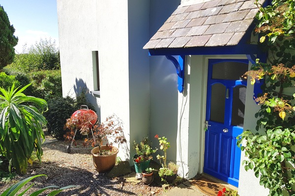 The attractive front door to Granary Cottage with BBQ nearby