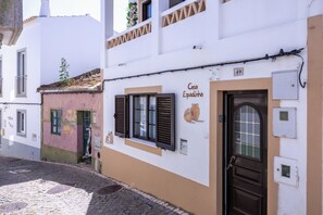 A building with a sign reading 'Casa Espadinha' and a brown door.