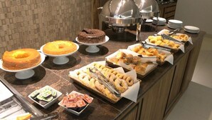 A buffet with various food items including cakes, donuts, and pastries. - Hotel Solaris (Formosa)
