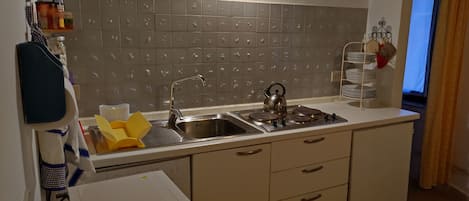 Fridge, microwave, stovetop, coffee/tea maker
