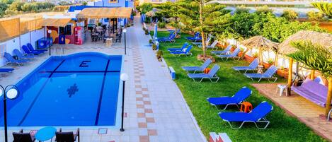 Seasonal outdoor pool, open 9:30 AM to 8:00 PM, pool umbrellas